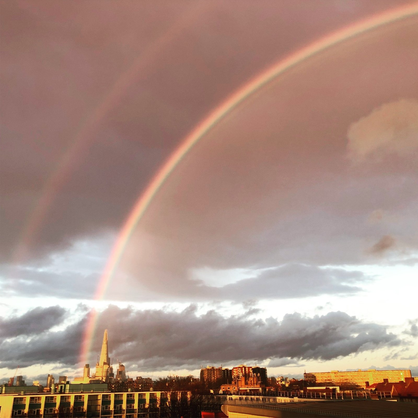 Double rainbow arcing over the Shard at dusk